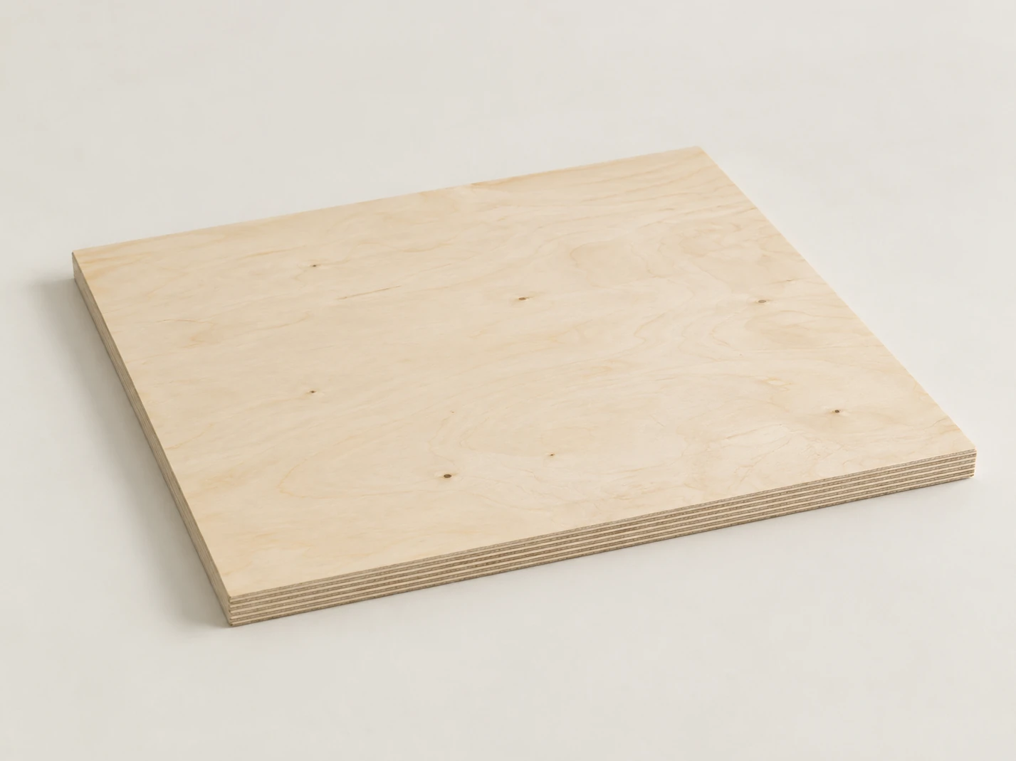 One full birch-faced plywood panel with a pale cream face, soft wavy figure and small pin knots, its edge showing thin veneer layers