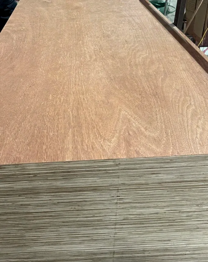 Reddish-brown hardwood plywood face meeting a pale layered edge at the corner of a stack