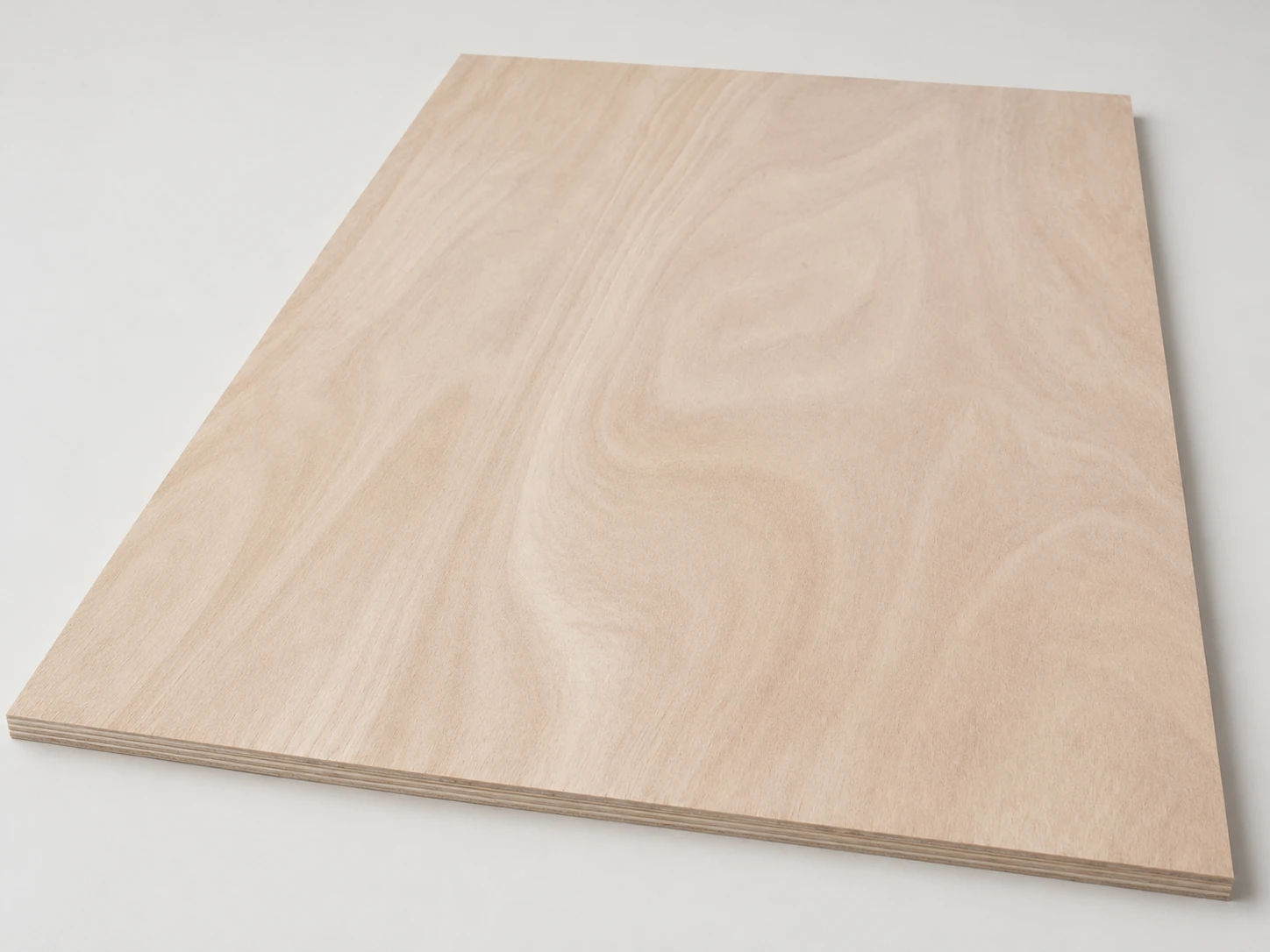 One full okoume-faced plywood panel with a pale pink-beige face and broad flame figure on a pale surface