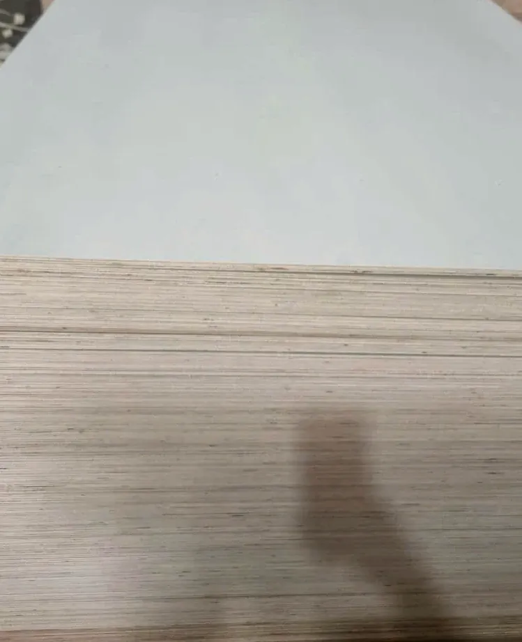 Long side of a poplar plywood stack with hundreds of pale sheet edges lined up flush